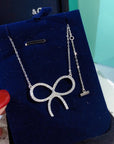 CLAW SET RHODIUM PLATED BOW NECKLACE