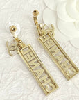 CC TEXT DIAMOND PAVED LIGHT GOLD DROP EARRINGS